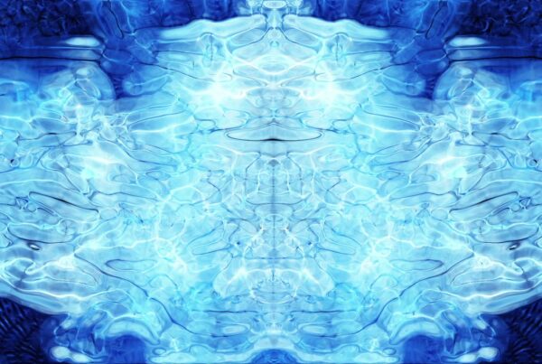 Abstract blue animating Rorschach pattern with fluid lines and symmetrical reflections creating a soothing, harmonious effect.