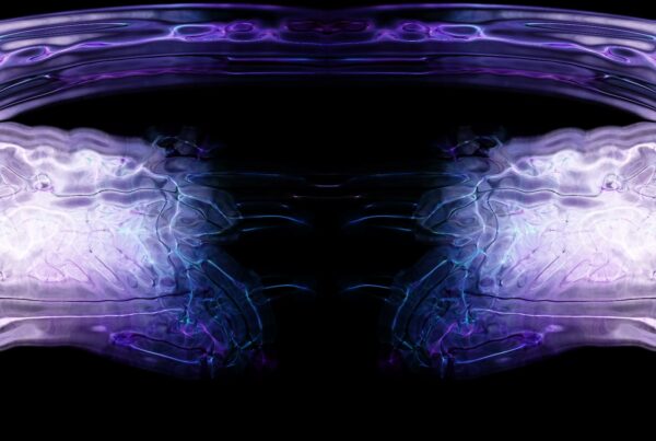 An abstract video loop featuring symmetrical waves in shades of purple, blue, and black, creating a mesmerizing mirror-like design with intricate, flowing patterns.