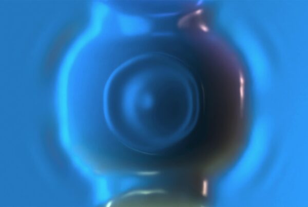 Abstract 4K looping video of a fluid metallic blue surface with reflections.
