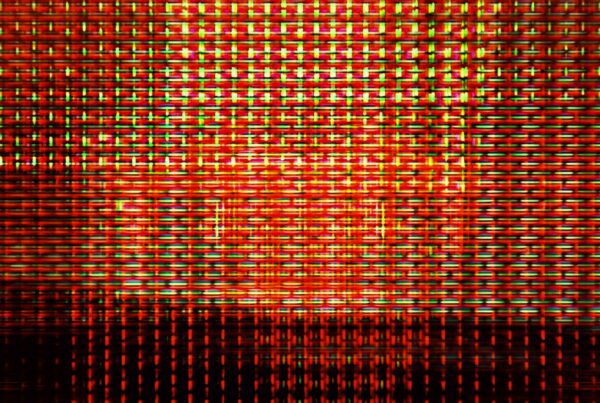 Abstract digital glitch art video loop with vibrant red, green, and yellow intersecting lines forming a colorful grid pattern.