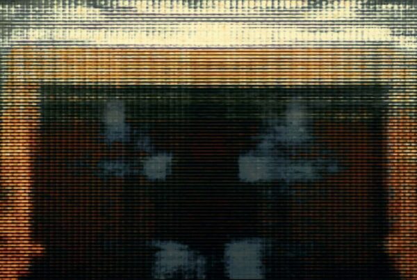 Video loop close-up image of a textured, golden surface with horizontal lines, giving a modern and industrial appearance.
