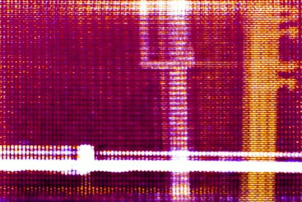 Vibrant abstract video loop of a digital technology screen featuring a purple and yellow grid patterns with intersecting lines, creating a textured and dynamic visual effect.