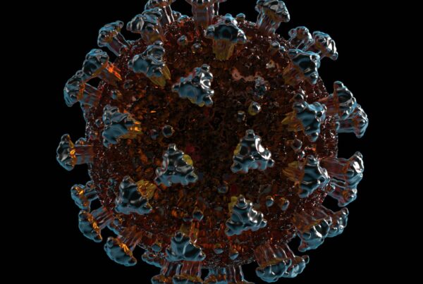 Detailed 4K video close-up view of virus structure with prominent spikes and textured core in ambient lighting.