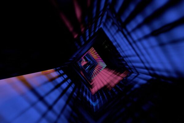 Abstract video loop of a geometric tunnel with vivid blue and pink hues creating a futuristic, infinite perspective.