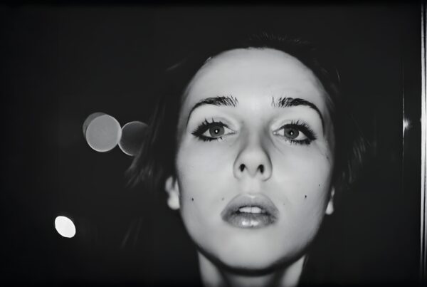 Black and white portrait of a woman with dramatic lighting.