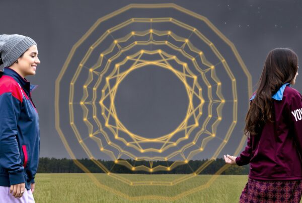 Two people in jackets standing in a field with a glowing geometric pattern in the background.