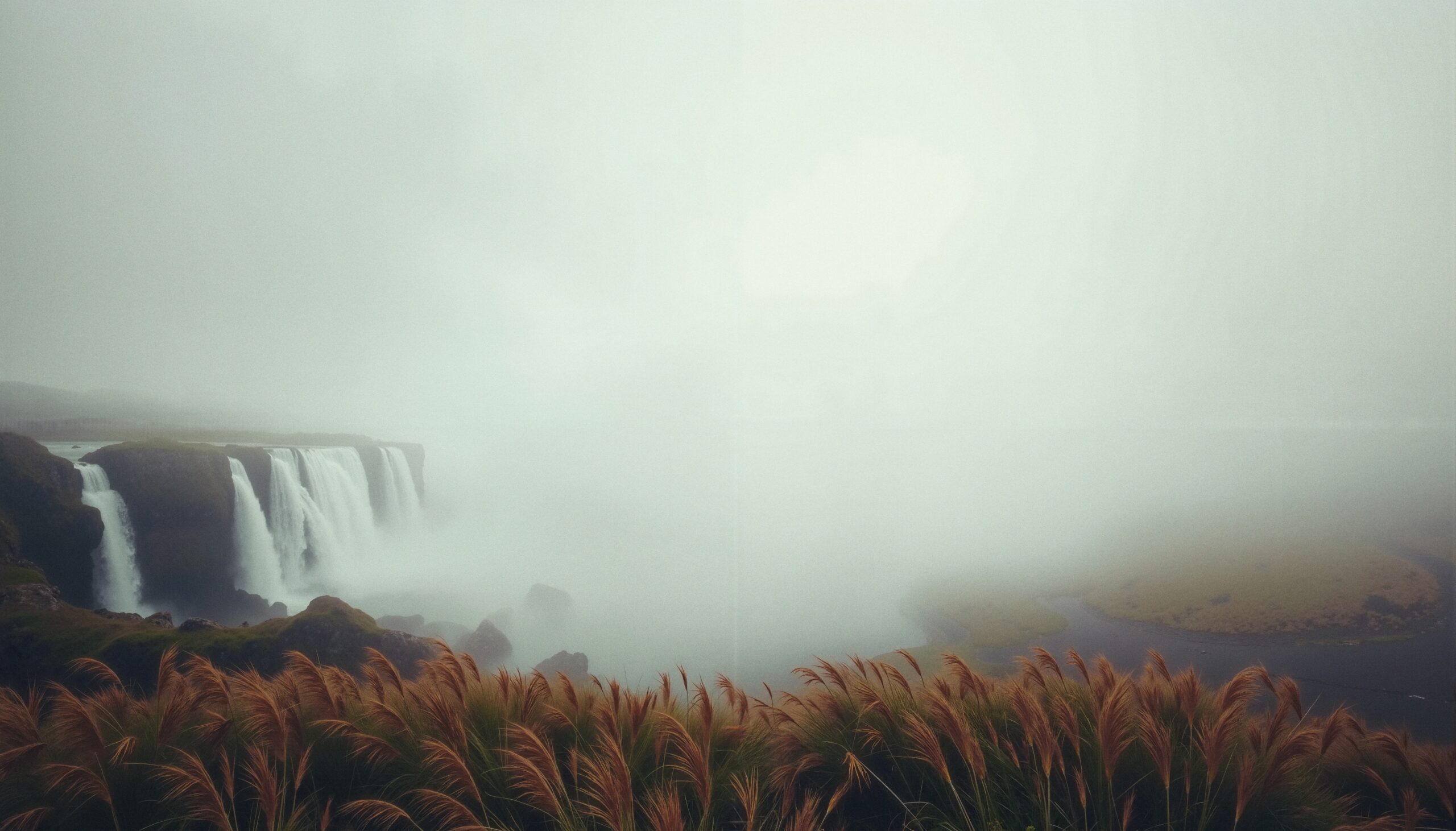 Misty Waterfall in Foggy Landscape