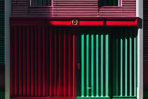 A modern facade with vibrant red and green panels, creating a striking architectural design.