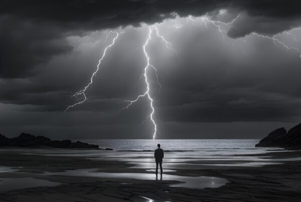 A person stands on a beach under a dramatic lightning storm, creating a powerful contrast with dark clouds and reflections in the wet sand.