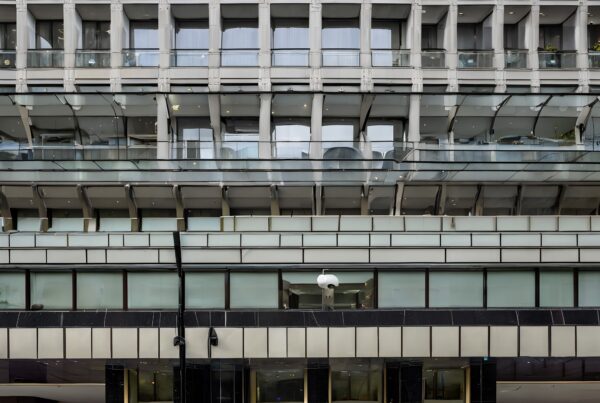Contemporary building facade with glass, metal, and gold doors.