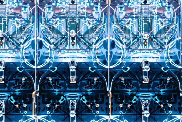 A symmetrical blue and white futuristic pattern with geometric shapes.