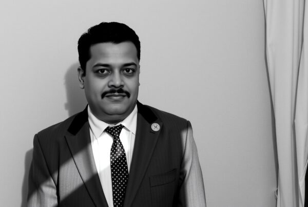 Man in business suit posing indoors.