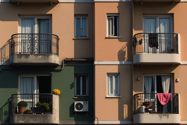 A vibrant residential building facade showcasing colorful balconies, plants, and urban life.