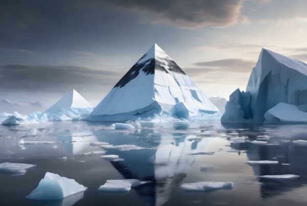 Surreal ice pyramids reflecting on tranquil arctic waters.