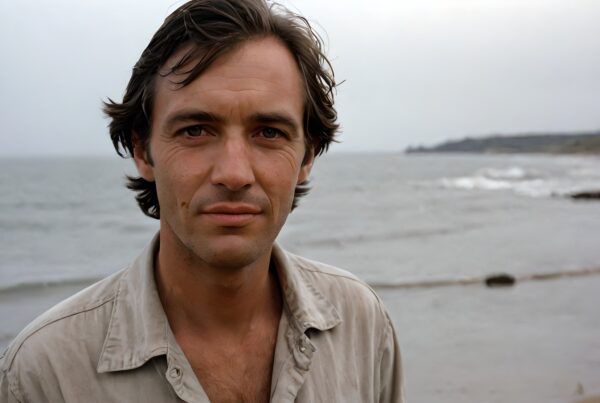 A contemplative man at the beach with ocean waves.