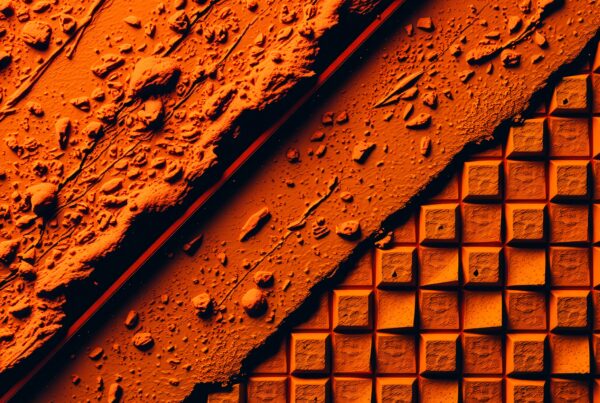Abstract image with contrasting orange textures, featuring rugged debris and geometric tiles.