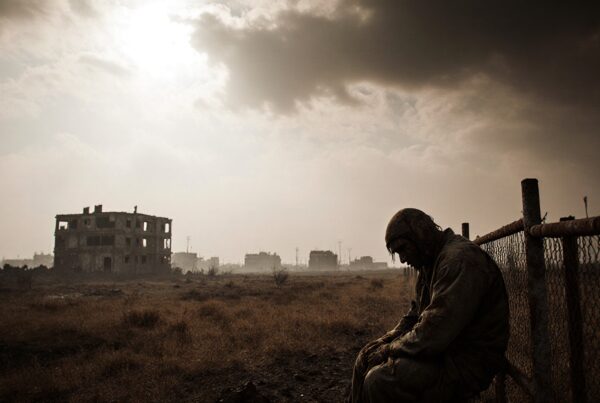 A lone figure in desolate landscape.