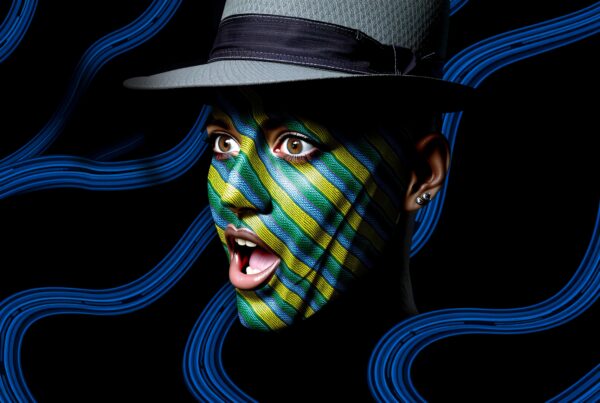 A person with a striped face paint and gray hat, surrounded by blue wave lines on a dark background.