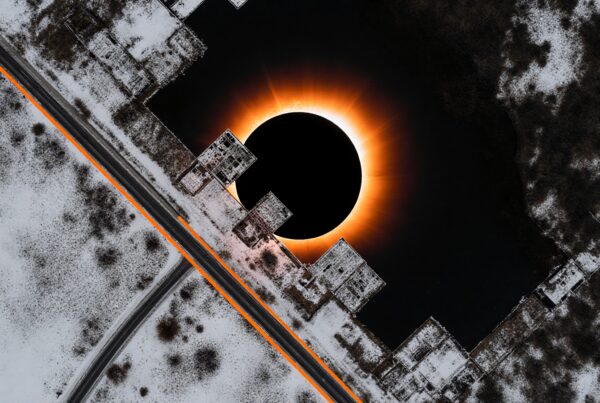Aerial view of a glowing eclipse surrounded by a snowy landscape.