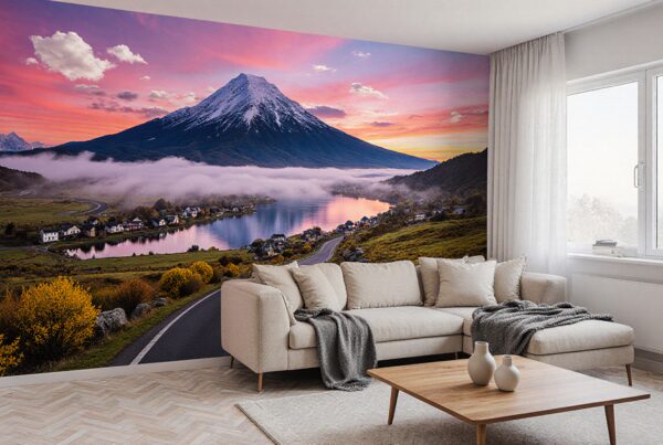 A modern living room featuring a large mural of a mountain landscape with a sunset, lake, and village.