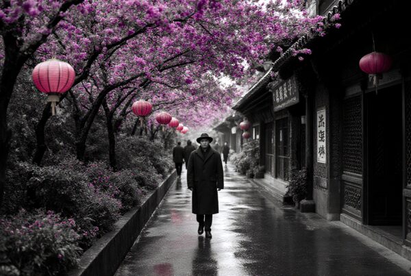 A lone figure on a rainy street with cherry blossoms and red lanterns.