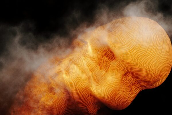 Abstract formation with golden lines against a dark background surrounded by smoky mist.