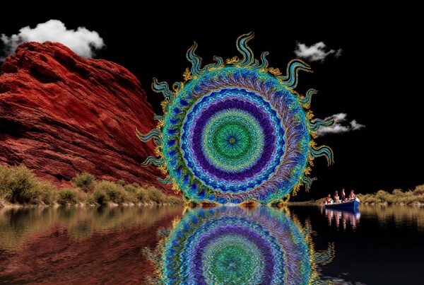 A colorful mandala reflects on a lake beside a striking red rock formation with a small boat in the distance.