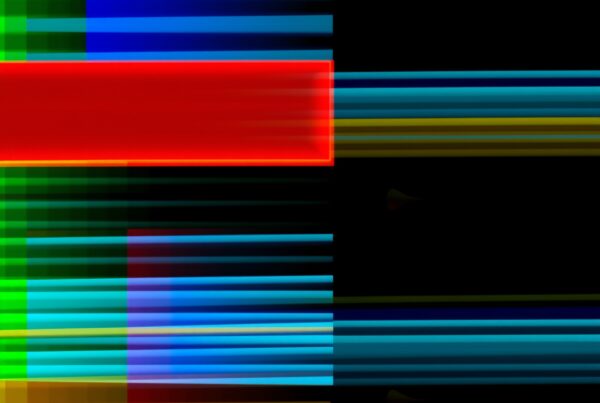 Abstract geometric art with colorful intersecting lines, a red rectangle, and a black background for modern design.