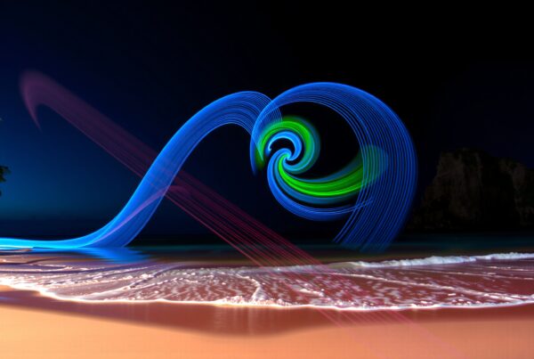 Enchanting night beach scene with colorful light painting.