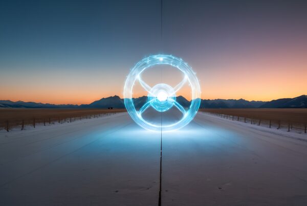 A luminous circle glows on a snowy road at twilight with mountains.