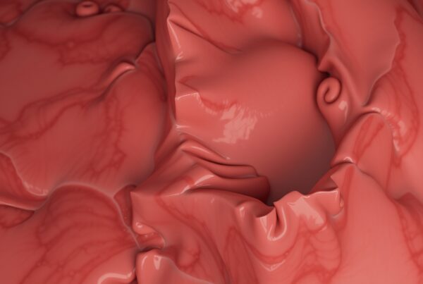 Close-up of abstract red organic texture with glossy, undulating surfaces.