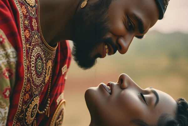 A loving couple in royal attire sharing an intimate moment outdoors.