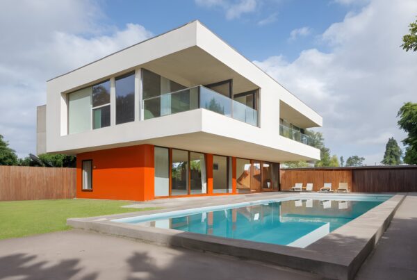 Modern house with large windows and a swimming pool.