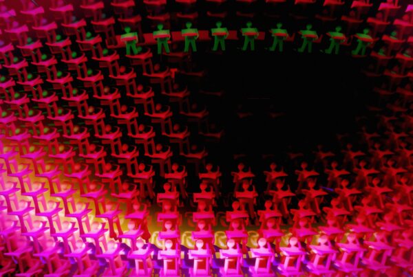 A vibrant mosaic of human figures in red and green, creating an intricate and dynamic pattern.