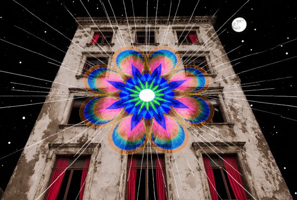 A surreal image of a colorful mandala design superimposed on a vintage building against a starry night sky.