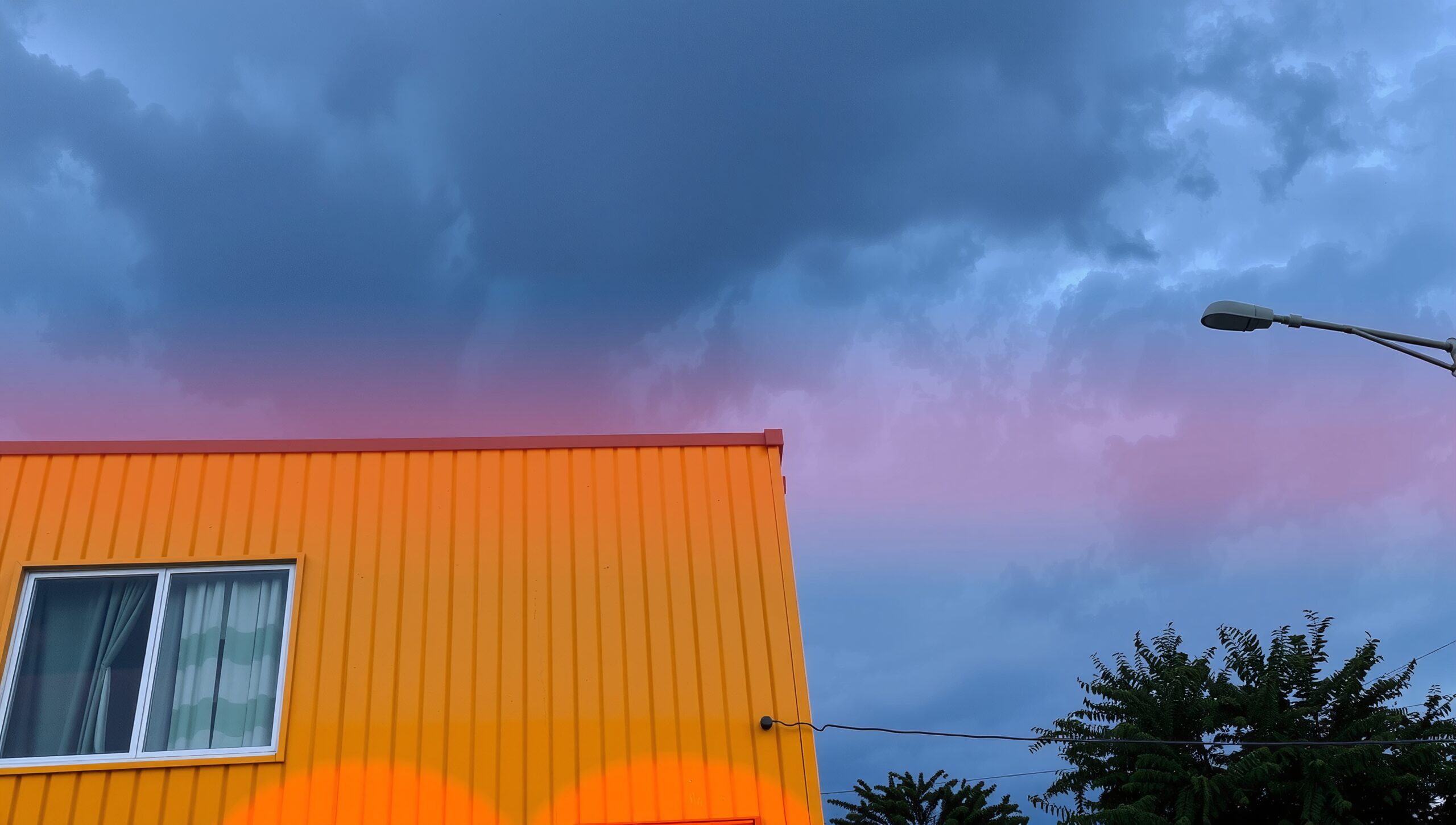 Vibrant Building Under Stormy Sky