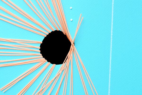 Abstract image with a turquoise background, black circle, and peach lines radiating outward for a dynamic, artistic composition.