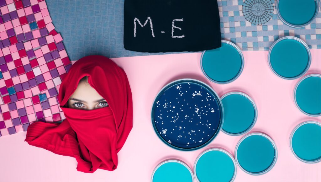 Red Headscarf and Lab Dishes on Pink Surface