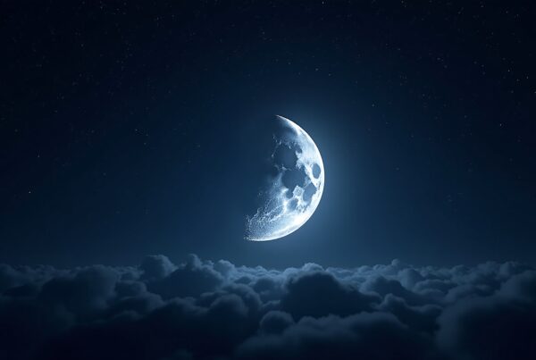 A crescent moon and stars over softly lit clouds.