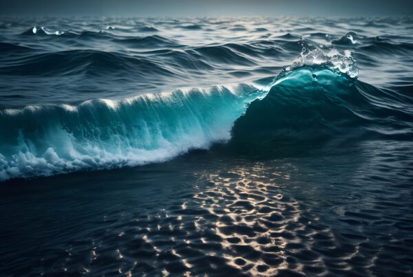 Dramatic ocean wave at sunrise or sunset, capturing ripples and