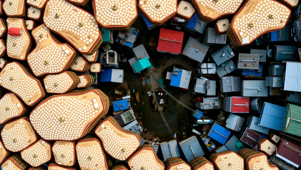 Aerial view contrasting golden structures with colorful urban rooftops.