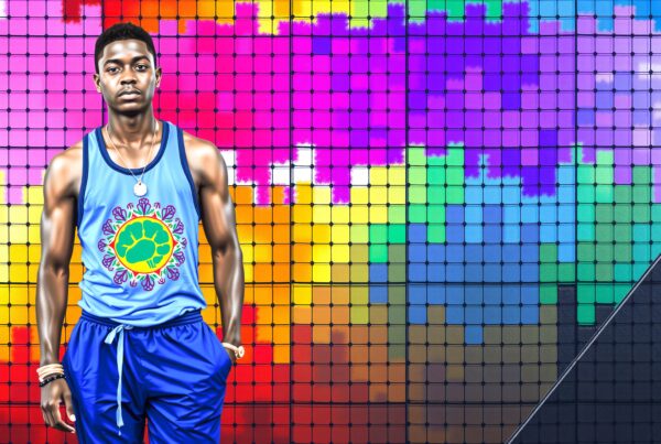 Young Black male athlete posing in colorful pixelated rainbow background wearing blue sports outfit