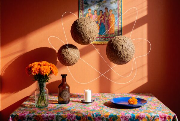 A vibrant room with art, flowers, and floating spheres above a colorful table.