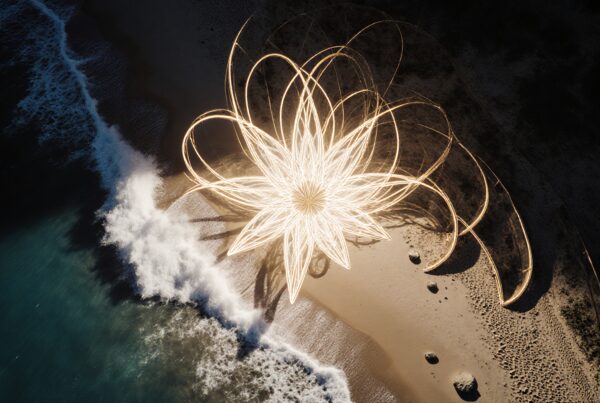 Stunning illuminated beach scene with intricate light art.