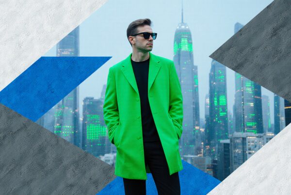 A stylish man in green coat stands stylishly before a neon-lit cityscape.