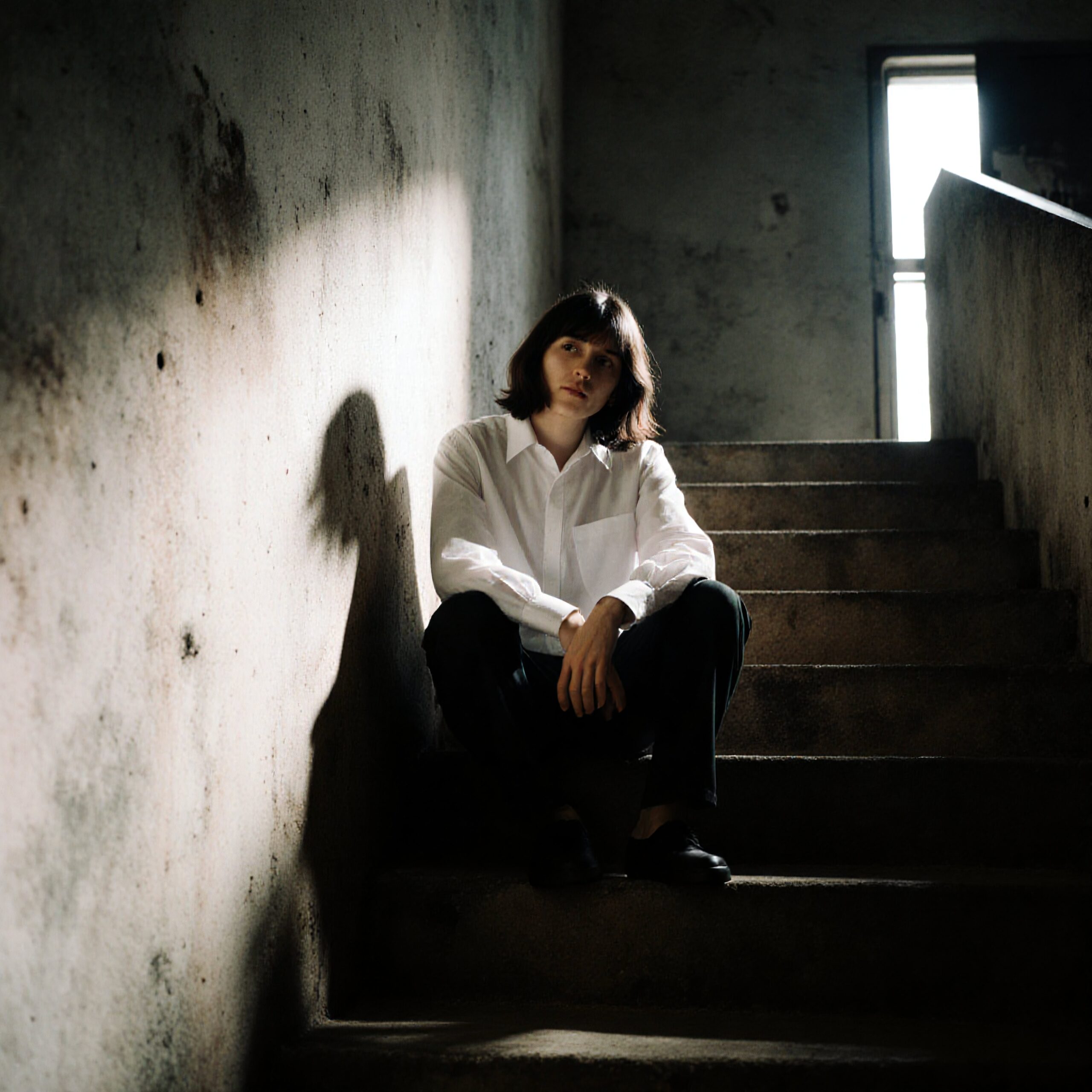 Introspective Moment on Urban Stairs