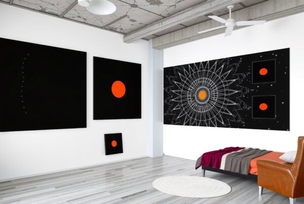 A modern room with geometric artworks, featuring vibrant orange circles on black backgrounds and minimalist industrial design.