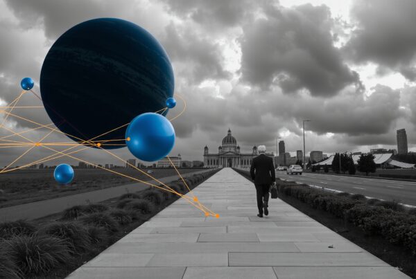 A man walks toward a classical building under a dramatic sky with surreal blue spheres floating in the foreground.