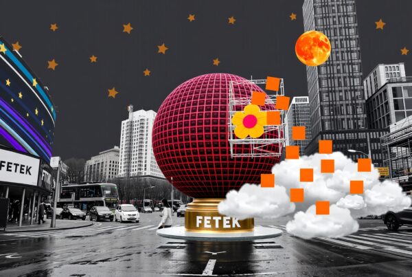 A large red sphere with a yellow flower at an urban intersection under a starry sky.