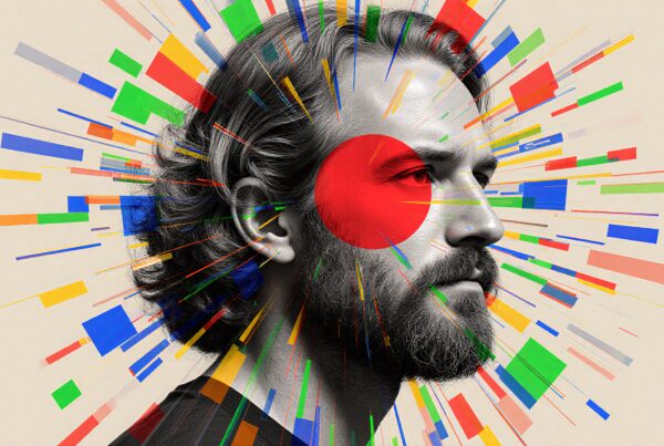 A vibrant abstract portrait of a man with dynamic, colorful geometric shapes radiating around him, creating a striking visual contrast on a neutral background.
